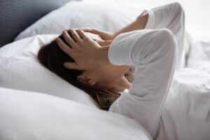 Woman in bed frustrated by Restless Leg Syndrome in Minneapolis, MN